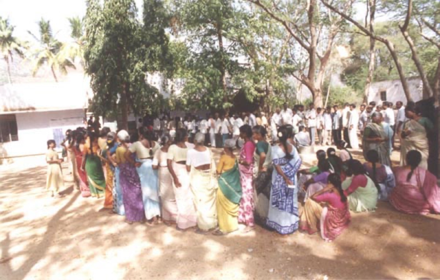 Voters queuing at a polling station in India